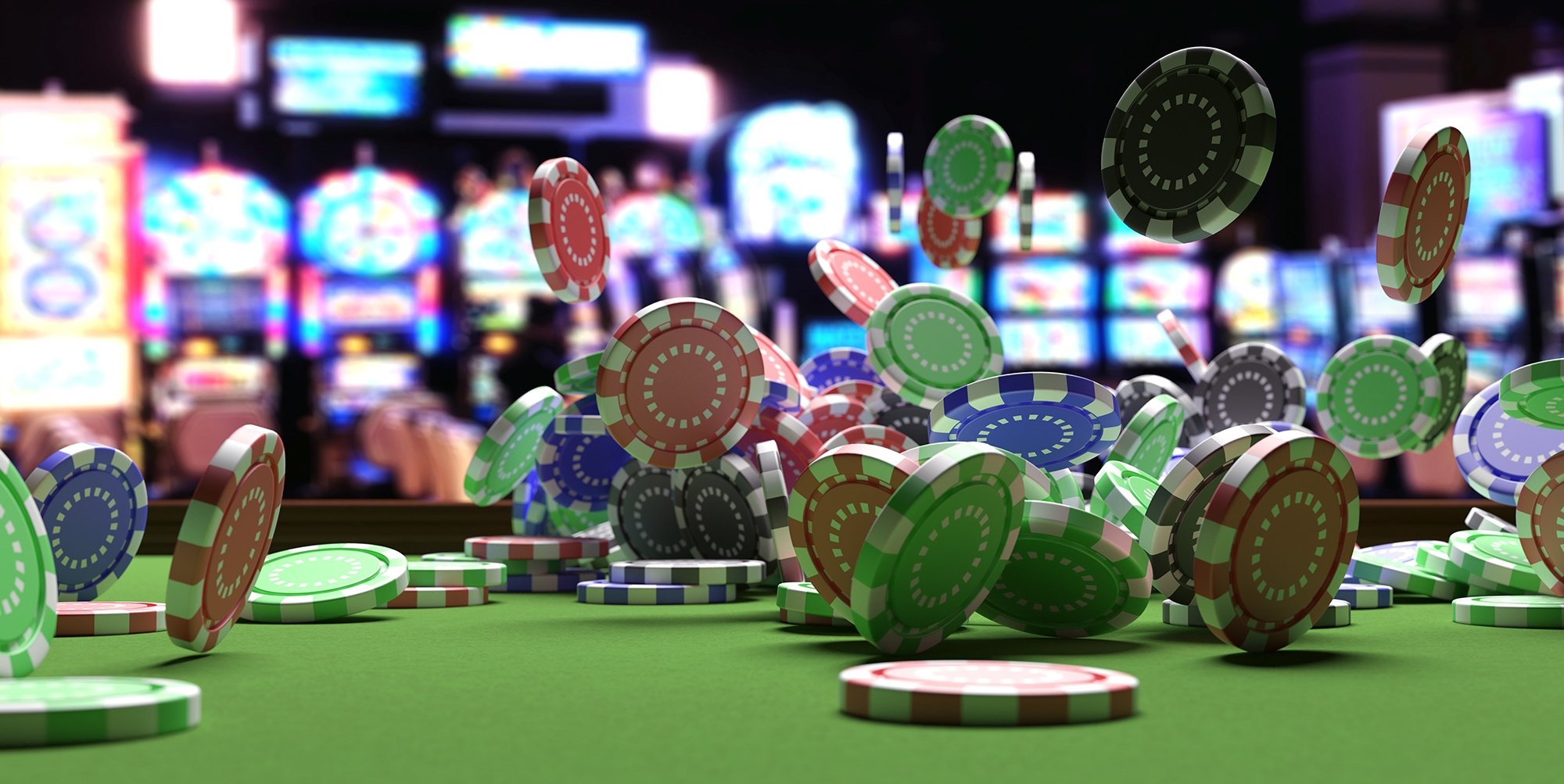 Colorful poker chips falling on to game table