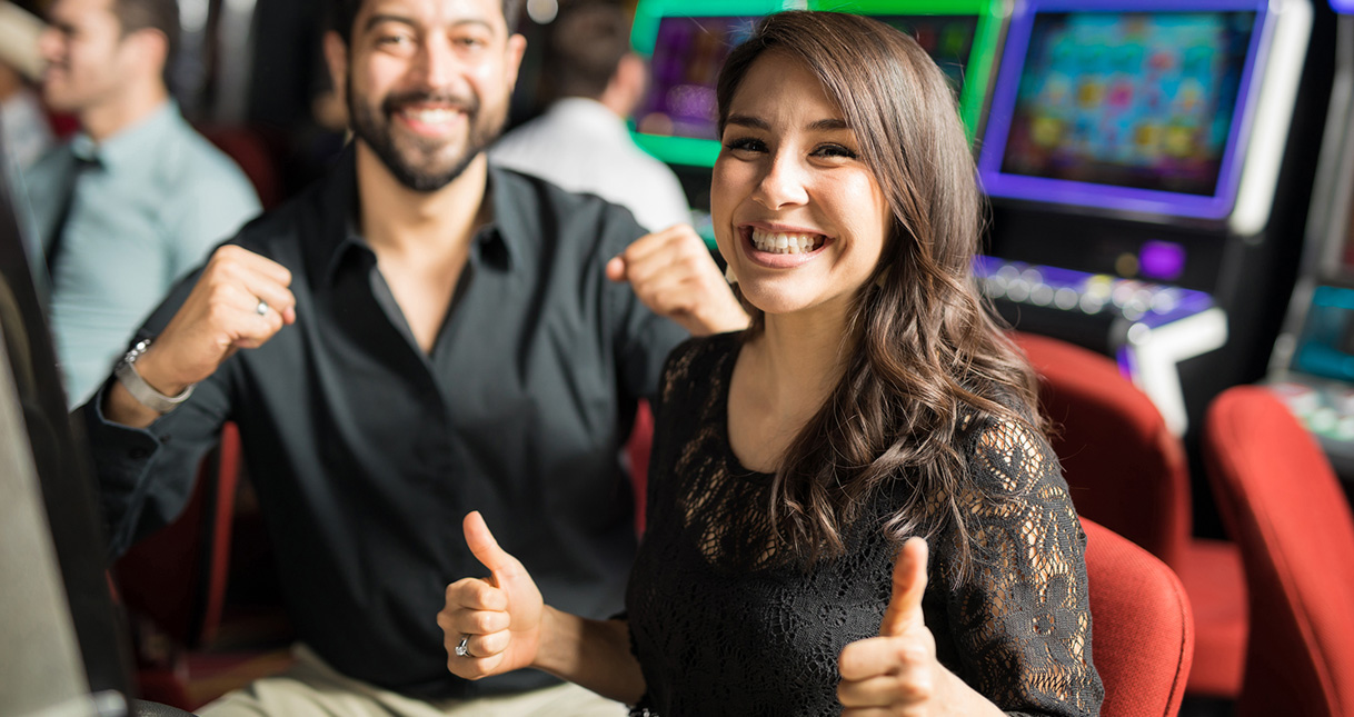 Couple excited at slot machine