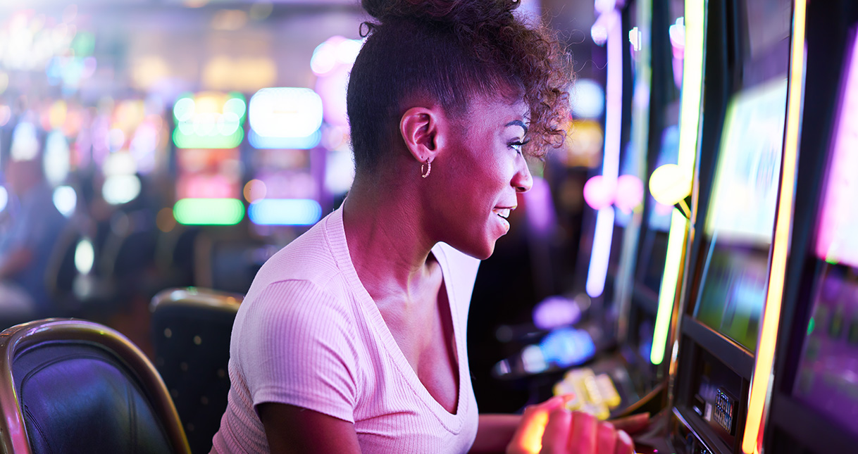 Woman playing slot machine